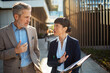 © Davor - Business colleagues discussing project outdoors in city