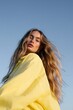© Andrii Zastrozhnov - Portrait of a young woman with long hair in a yellow shirt against clear blue sky for fashion background and banner design