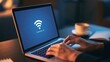 © AZ Studio - Person typing on laptop with Wi-Fi connection lost error message on screen