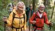 © Jos - Happy senior friends hiking together on a lush forest trail with trekking poles