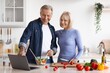 © Prostock-studio - Smiling Elderly Caucasian Man And Woman Joyfully Preparing Healthy Meal Together In Modern Kitchen, Enjoying Cooking Process While Using Laptop For Recipe Inspiration. Weight Loss Concept.