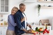 © Prostock-studio - Smiling Elderly Caucasian Man And Woman Enjoying Cooking Together At Home In Kitchen, Preparing Fresh Vegetables And Sharing Joyful Moment, Expressing Affection. Family Bonding Concept.