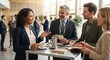 © Максим Новосветлов - Diverse business colleagues networking and drinking coffee at high table during corporate conference event.