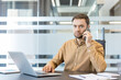 © Liubomir - Professional businessman talking on smartphone in modern office.