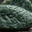 © Zha Stock - Closeup of Ancient Green Jade Carving with Intricate Patterns.