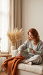 © Larisa - Young woman relaxing on a sofa with a cup of tea in a cozy living room