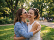 © ideas - Two joyful sisters sharing a warm hug and affectionate moment outdoors in a beautiful sunny park, celebrating sisterhood, family love, friendship, and togetherness on National Sister Day.