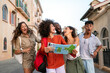 © NDABCREATIVITY - Friends enjoy a summer afternoon exploring the city, laughing over a map and discovering the city