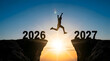 © AqsaiQbal - Silhouette of a person jumping across a gap between cliffs labeled 2026 and 2027 at sunrise