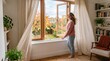 © design - Woman enjoying fresh autumn air by opening a window in a cozy room with bookshelves and plants