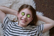 © ADDICTIVE STOCK - Smiling girl relax with cucumber slices over eyes