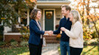 © Matos - Real Estate Agent Hands Over House Keys to Happy Couple Outside New Home