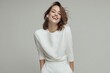 © Papisut - Confident woman with bright smile wearing a white outfit soft even lighting joyful and professional studio portrait