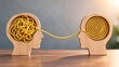 © Sabri - 'Two wooden head profiles connected by a wire showing tangled chaos transforming into organized spiral representing communication and problem solving'