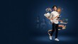 © graphic designer - Ambitious young student looks upward holding book surrounded by floating learning symbols and blurred classmates on deep blue backdrop for academic campaign.