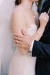 © VolodymyrNadtochii - Close up of bride and groom embracing at wedding
