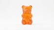 © Farid - Orange gummy bear candy standing on white background