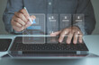 © MUNTHITA - Businessman using laptop review digital recruitment checklist with candidate selection interface, HR evaluation, talent screening and workforce management, online hiring process, employee assessment.