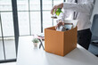© Charlie's - Businessman Carrying Cardboard Box packing Stuff Resign Depress or carrying business cardboard box Change of job or fired from company resign.