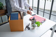 © Charlie's - Businessman Carrying Cardboard Box packing Stuff Resign Depress or carrying business cardboard box Change of job or fired from company resign.