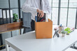 © Charlie's - Businessman Carrying Cardboard Box packing Stuff Resign Depress or carrying business cardboard box Change of job or fired from company resign.