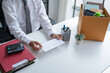 © Charlie's - Male Employee Handing in Resignation Letter Representing Career Transition Unemployment Workplace Stress Mental Health and New Beginnings.