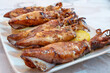 © Nuria Gonzalez Sanch - Grilled squid topped with garlic and herbs, presenting a delicious and healthy mediterranean seafood meal, High-Protein and Low-Mercury Seafood