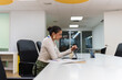 © pablo - Young businesswoman drawing on a digital tablet in a bright modern office