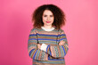 © deagreez - Confident woman in colorful patterned sweater posing with crossed arms against a bright pink background, casual portrait conveying style, attitude and winter fashion