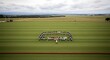 © Kamal - Aerial view of a polo team forming a semicircle on a vibrant green field during a match