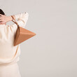 © UM STUDIO/Stocksy - Beige Shoulder Bag Fashion Accessory Close-Up