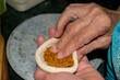© Tenacity_1987 - filling spicy sattu mixture into wheat dough to prepare traditional litti, classic Bihari food preparation