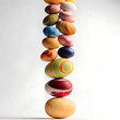 © Mol - Balanced stack of colorful painted Easter eggs on white background