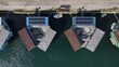 © Amazing Aerial - Aerial view of the Urban Rigger floating student housing complex featuring modular containers, solar panels, and central courtyards on the water in Kobenhavn, Kobenhavn, Denmark.