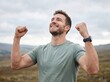 © Ikhbal - Happy man celebrating success with raised fists in nature