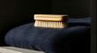 © regasa - Bamboo Brush For Fabric Care On Dark Woolen Garment