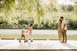 © BGStock72 - Joyful family moment by the lake during a warm afternoon in summer