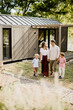 © BGStock72 - Family strolls together in a modern eco friendly house setting