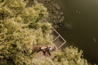 © BGStock72 - Couple enjoying a serene moment by the calm waters in nature