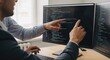 © Lee - Two developers collaborating closely while reviewing complex code on a computer screen in an office setting