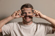 © ronstik - Anonymous identity and digital privacy concept with face hidden by phone