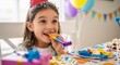 © Angavlan - Joyful girl enjoying birthday celebration with colorful party hat and festive accessories, smiling while holding party horn. Birthday celebration includes vibrant decorations and delicious treats.