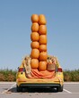 © Ryzhkov - Tall stack of orange pumpkins balanced in a car boot, featuring corn stalks and candy for trunk or treat and community event posters