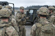 © muhammad - Group of soldiers gathering near military vehicle in muddy field, camouflage uniform troops briefing outdoor with forest background, tactical mission concept