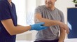 © Thimira - rehabilitation clinician supports forearm beside joint overlay to evaluate mobility, document functional progress, and coordinate recovery care
