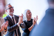 © Rawpixel.com - Smiling older white man and woman applauding at a professional event