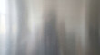 © Rabeka - Brushed stainless steel metal sheet texture background for industrial design aesthetics.