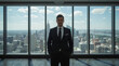 © siraphol - Successful businessman in suit overlooking city skyline with confidence and calm