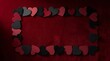 © Lilyaka - Valentine day frame with red and black paper hearts on a dark background