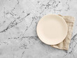 © Cagkan - Empty plate and linen napkin on marble background
